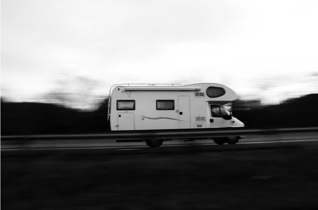 Motorhome whizzing by on the highway, to the right